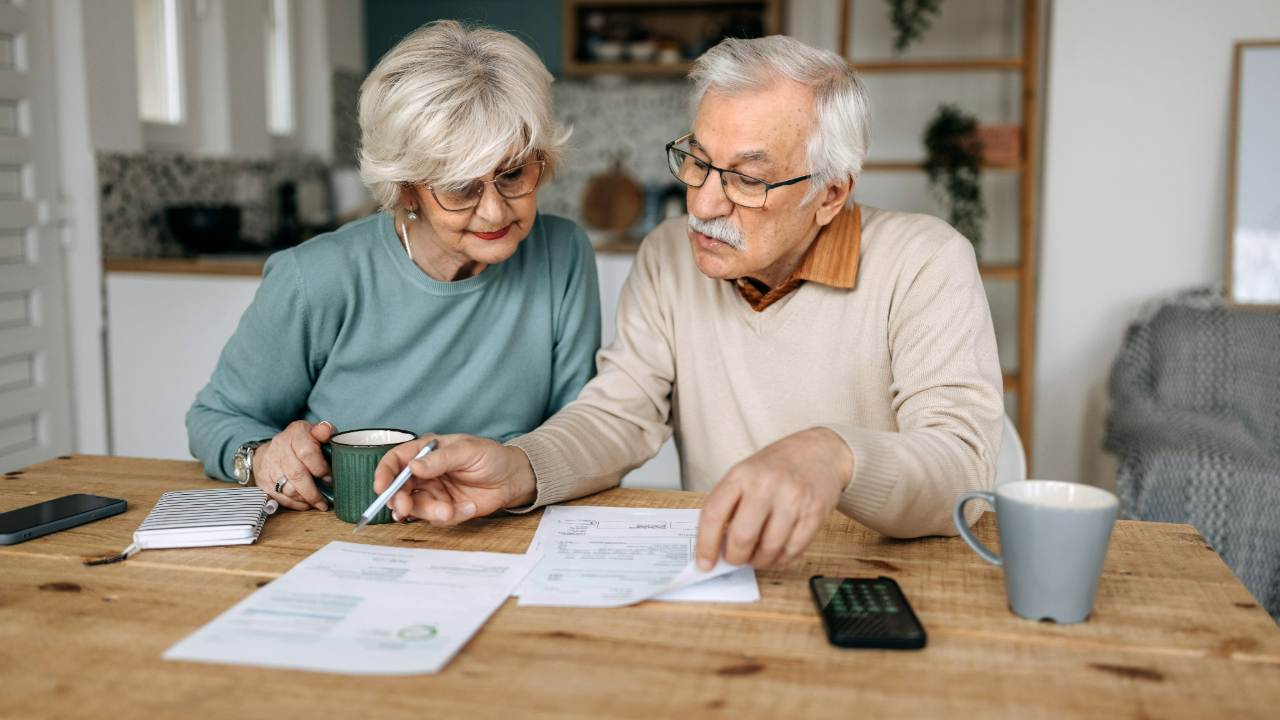 1780582659931_older couple taxes paperwork table getty